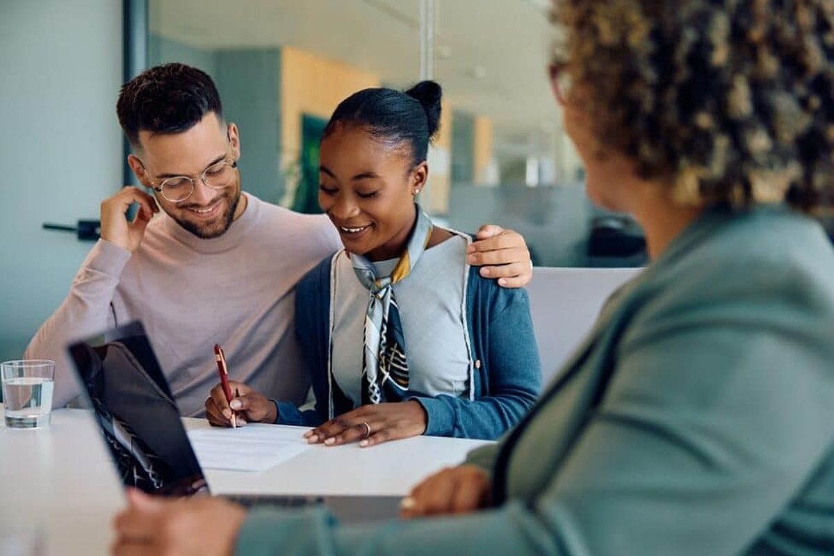 Couple speaking with a loan officer to consolidate their debt